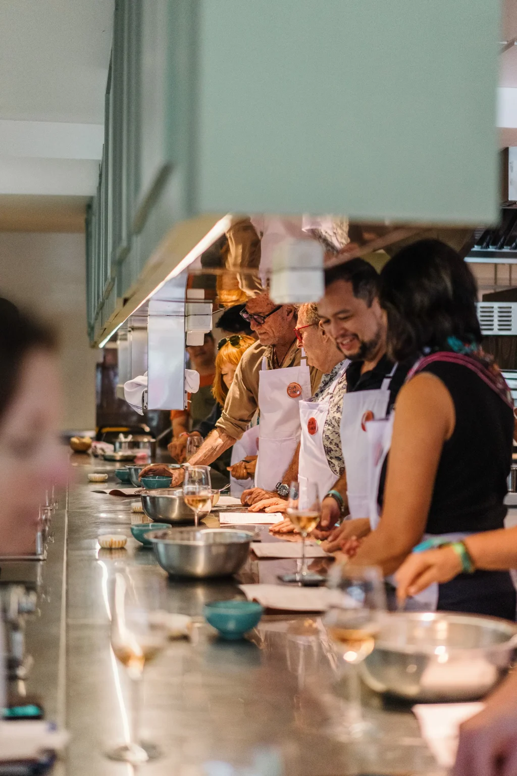 Guests at the counter during a hands-on cooking class learning pasta making